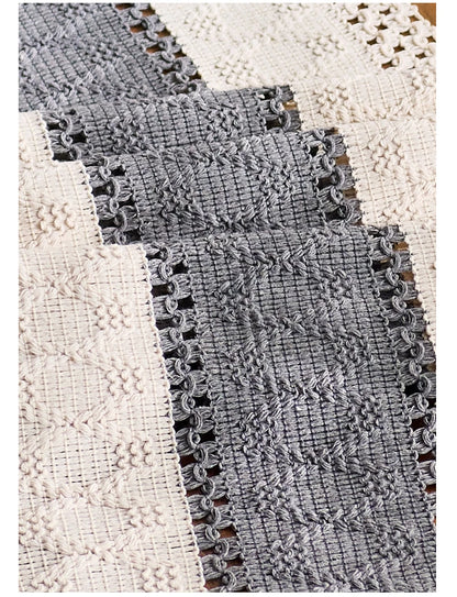 Close-up of textured fabric with a patterned edge on a white background
