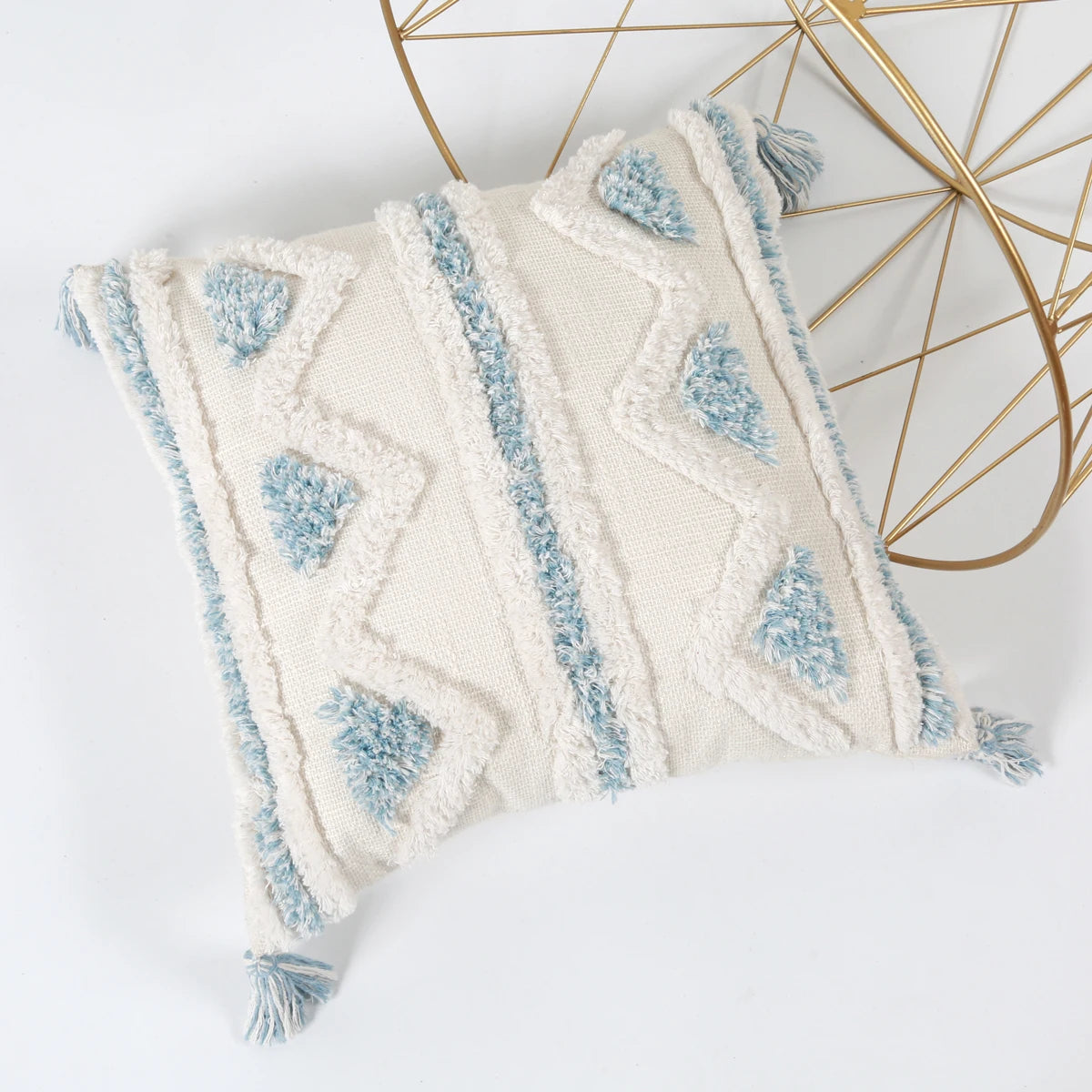 Decorative pillow with blue and white pattern on a white background