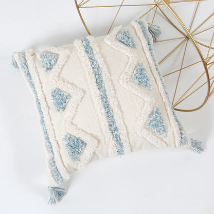 Decorative pillow with blue and white pattern on a white background