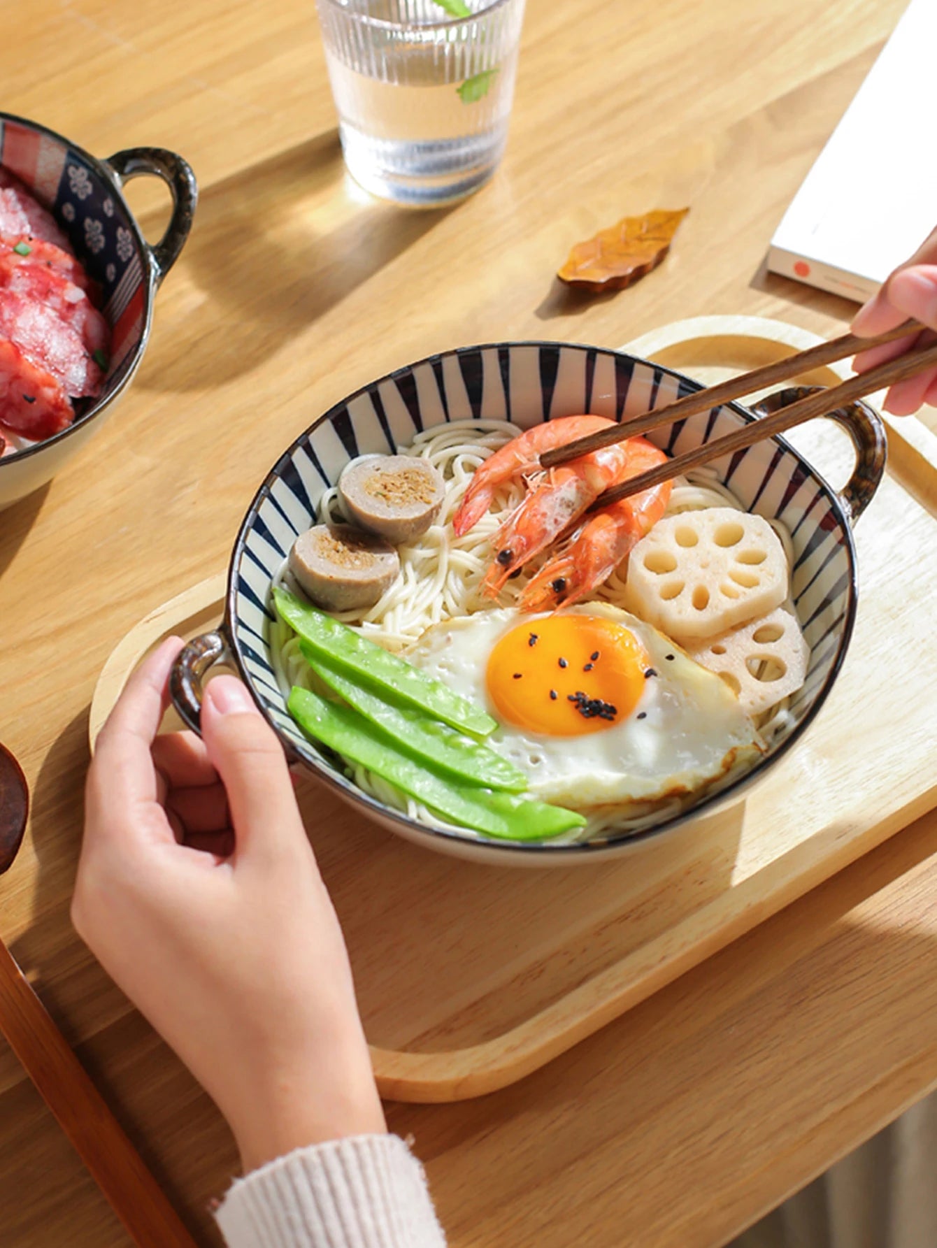 Noodle bowl with smiley face egg on a wooden table