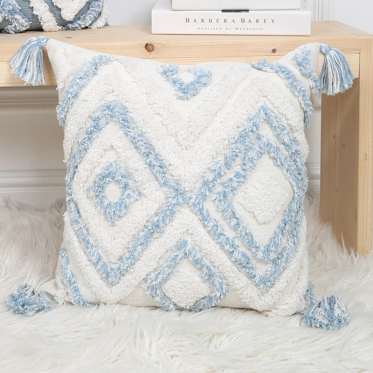 Decorative pillow with blue geometric pattern on a white surface