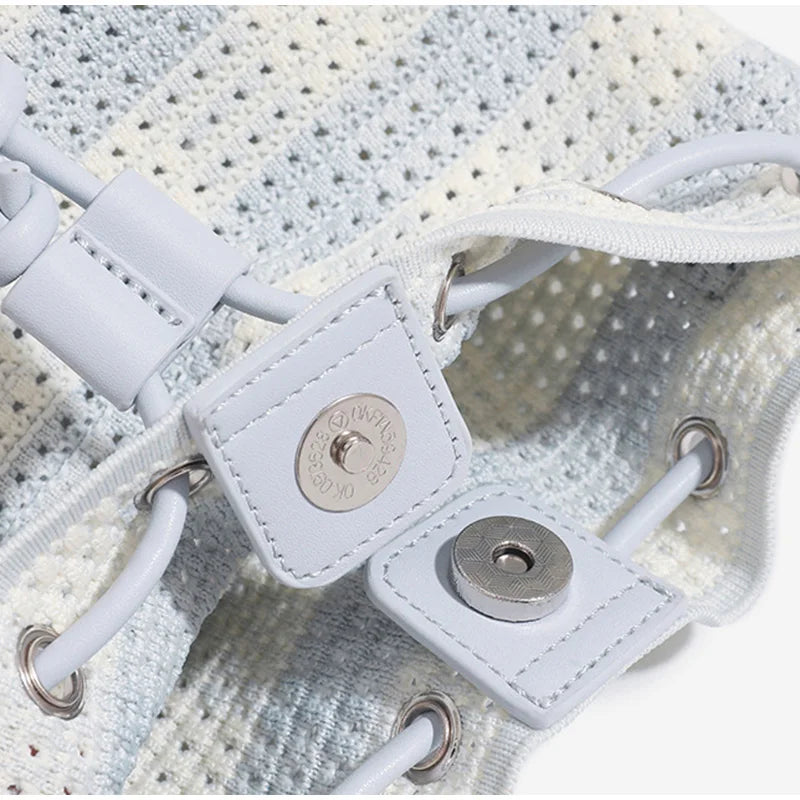 Close-up of a white sneaker with a brand logo on the side.