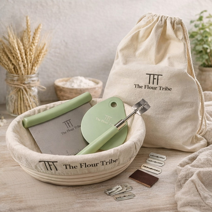 Baking tools and accessories with 'The Flour Tribe' branding on a wooden surface.