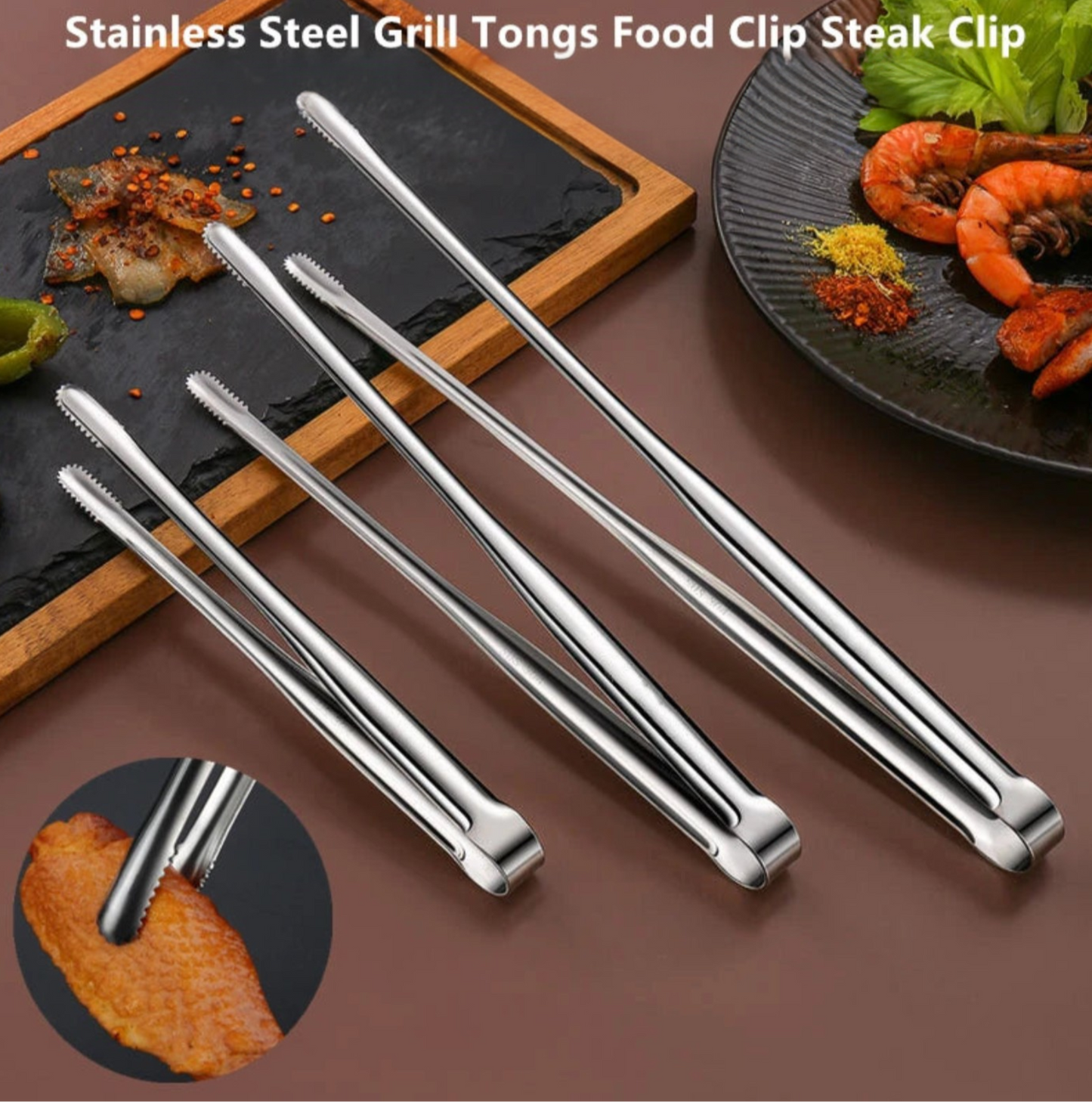 Set of stainless steel grill tongs on a brown surface with food in the background