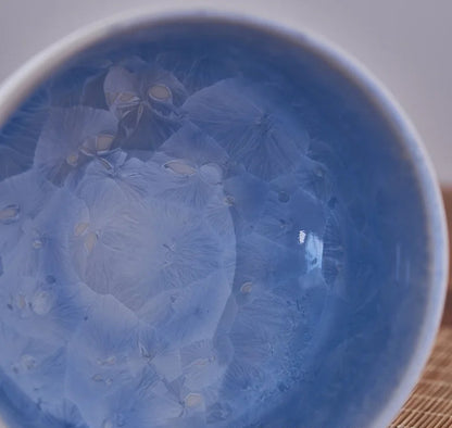 Blue ceramic bowl with floral patterns on a white background