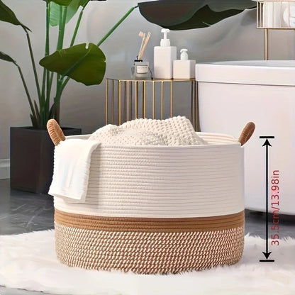 White and brown woven basket with a white towel on a light-colored floor, with a plant and small table in the background.