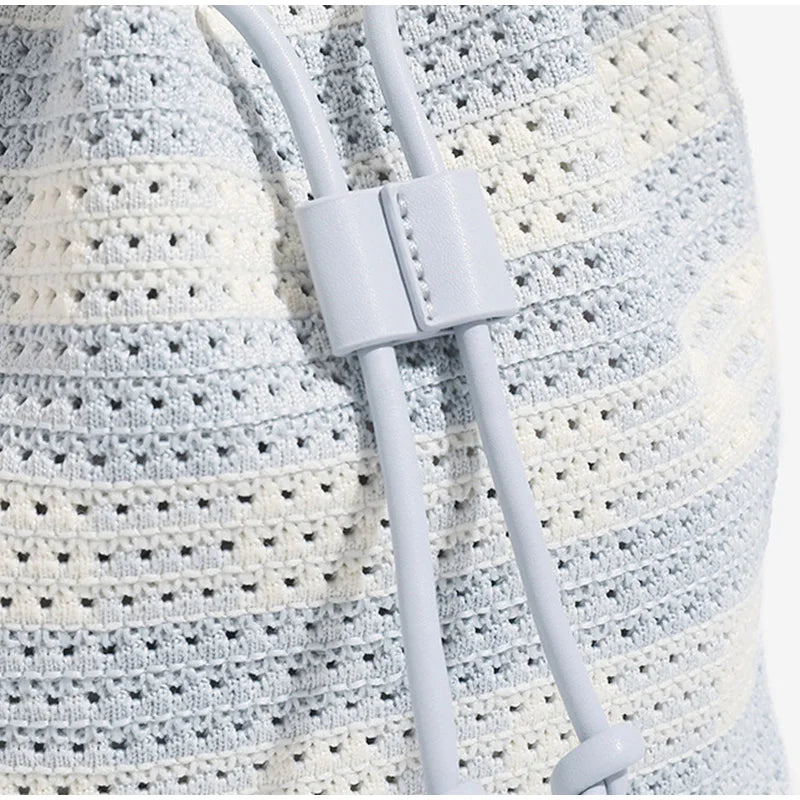 Close-up of a white strap with a buckle on a textured fabric background