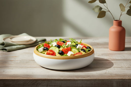 Colorful salad with vegetables in a white bowl with a wooden rim on a white background