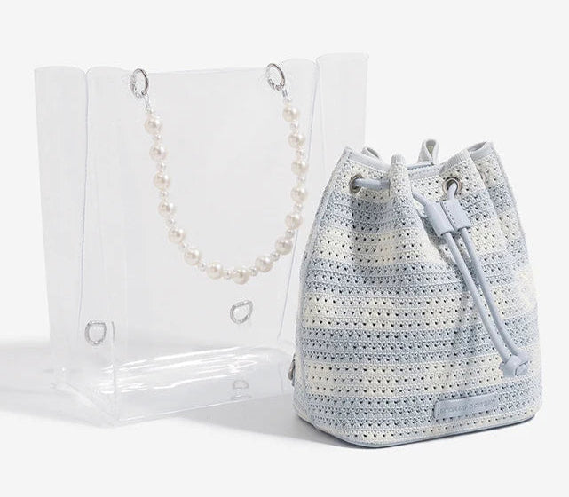 Crocheted bucket bag with drawstring and pearl chain on a white background