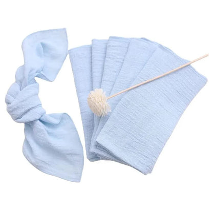 Set of light blue baby blankets, headbands, and a toy on a white background