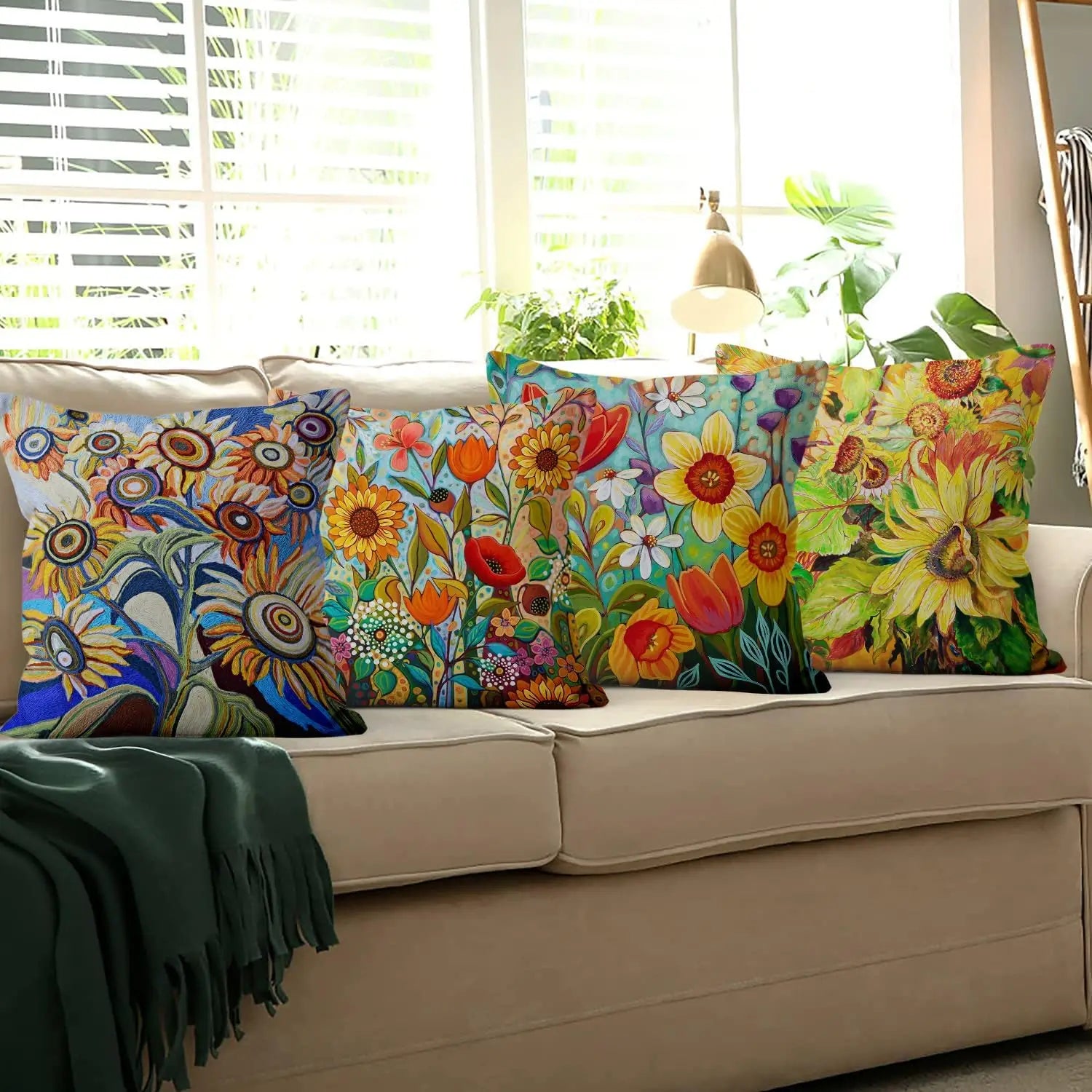 Colorful floral-patterned pillows on a beige sofa with a window in the background