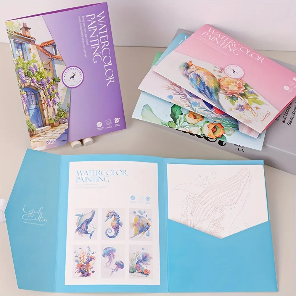 Watercolor painting books and stationery on a light surface