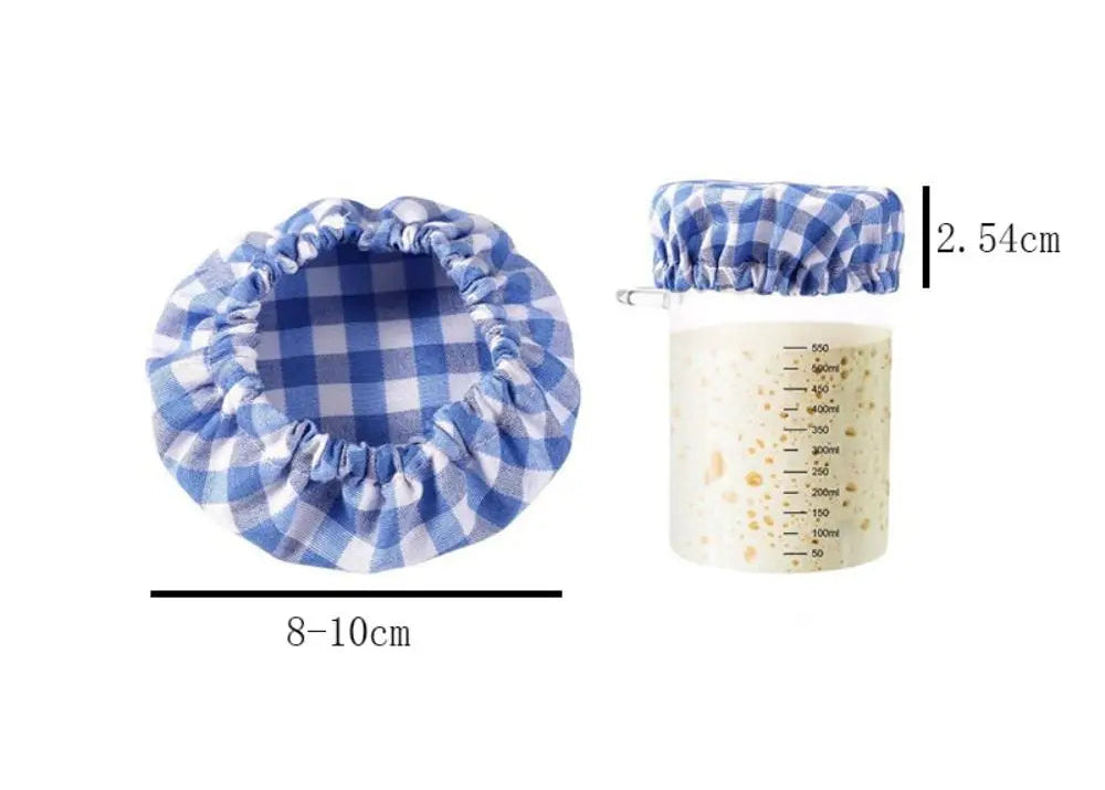 Blue checkered pot holder and measuring cup with measurements on a white background
