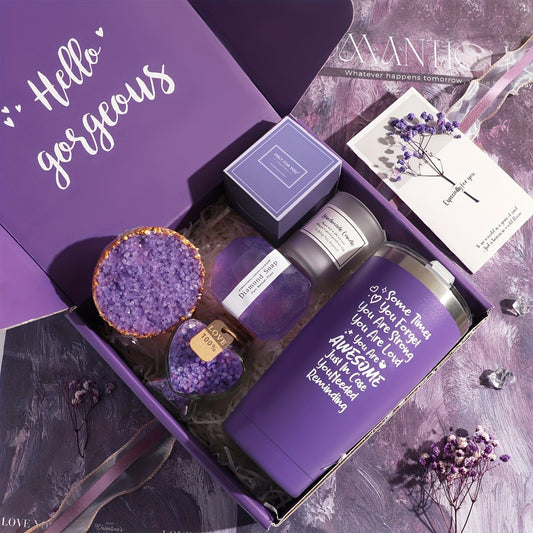 Purple gift set with a mug, small bottle, and decorative items on a textured surface.