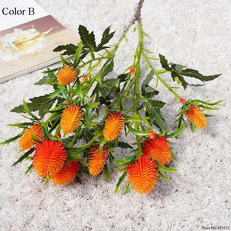 Artificial plant with orange flowers on a textured surface