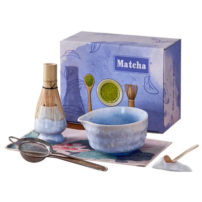 Matcha tea set with bowl, whisk, and box on a white background