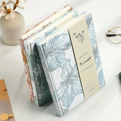 Floral notebook with a decorative cover on a white surface