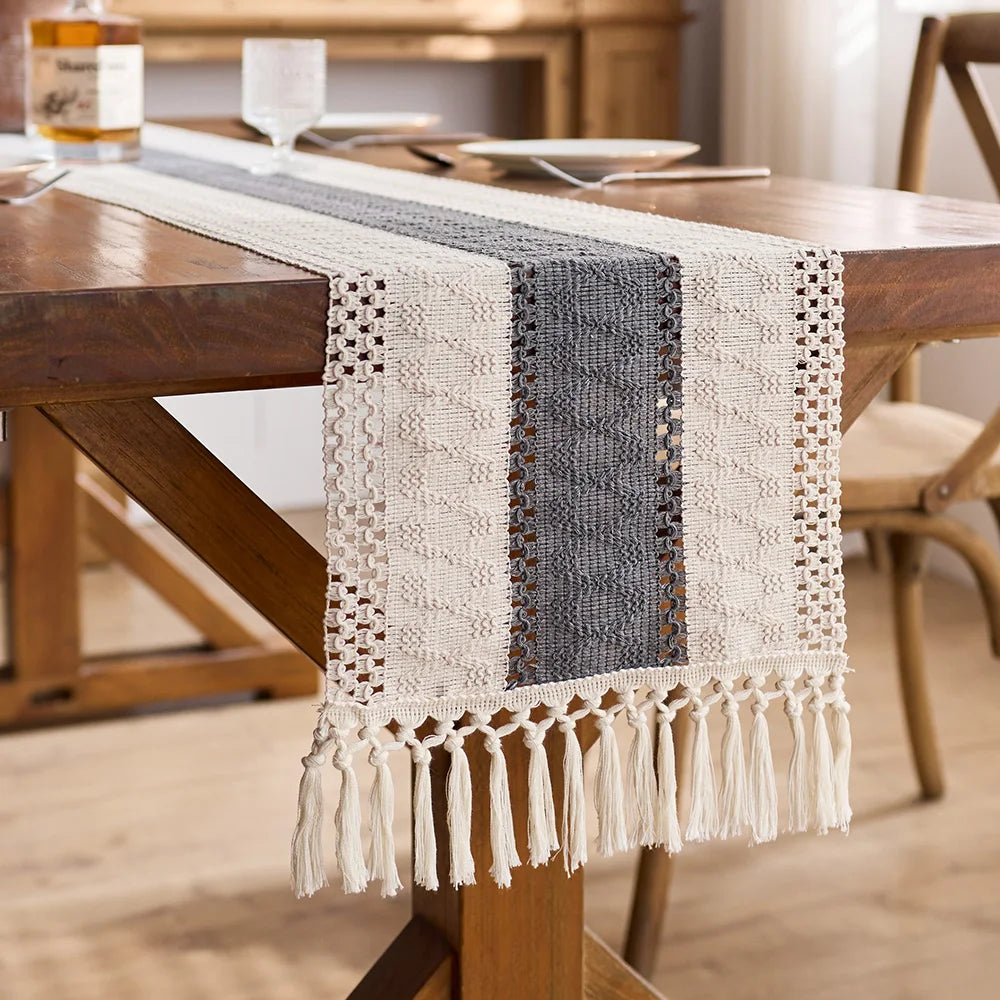 Textured table runner with tassels on a wooden dining table