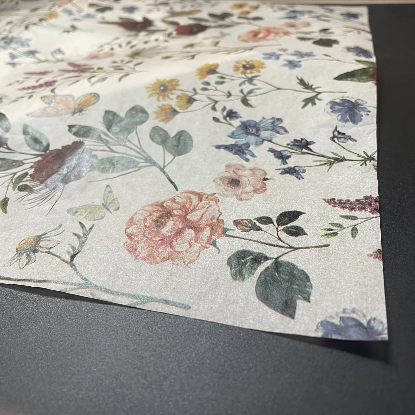 Floral patterned paper on a gray surface