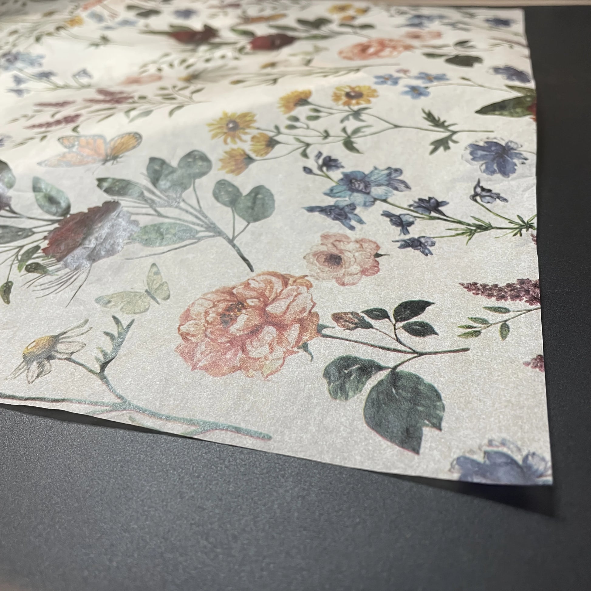 Floral patterned paper on a gray surface