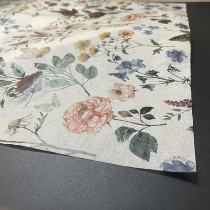Floral patterned paper on a gray surface