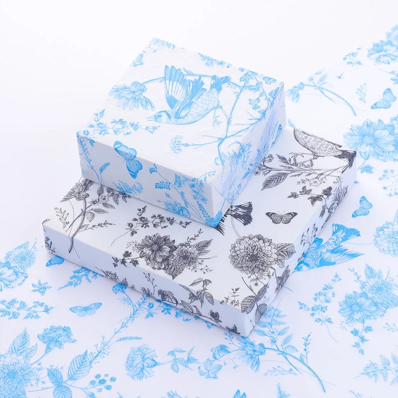 Two floral-patterned boxes on a matching fabric background