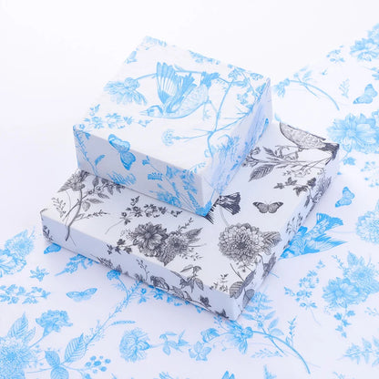Two floral-patterned boxes on a matching fabric background