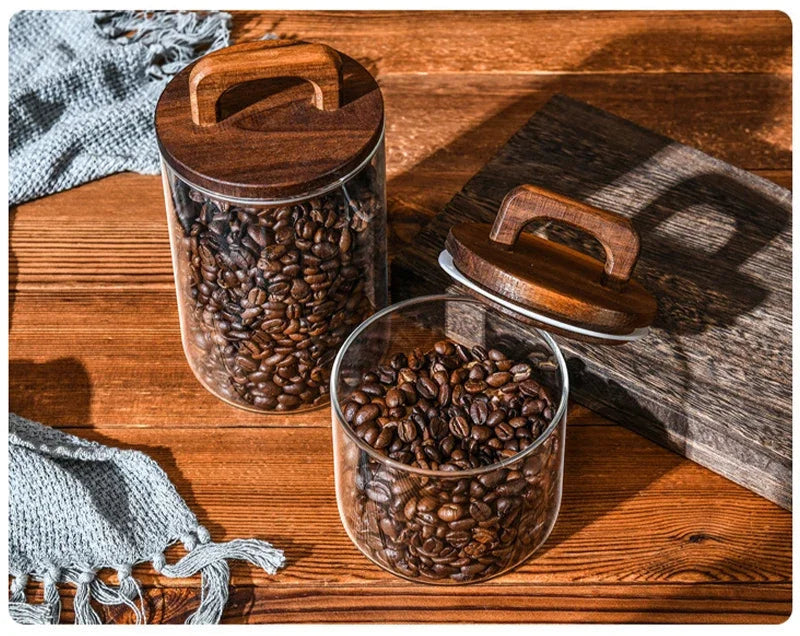 Two containers with coffee beans on a wooden surface