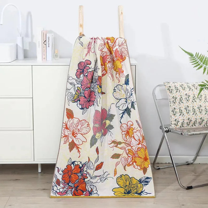 Floral towel hanging on a rack with a chair and cabinet in the background