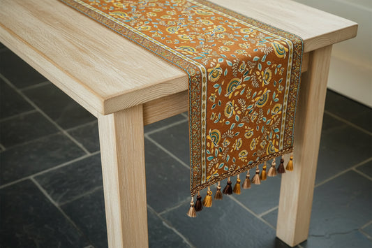 Decorative table runner with floral patterns on a wooden table.