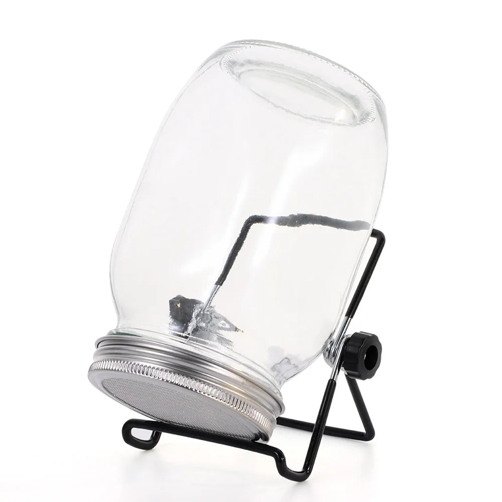 Clear glass jar with metal base and black stand on a white background