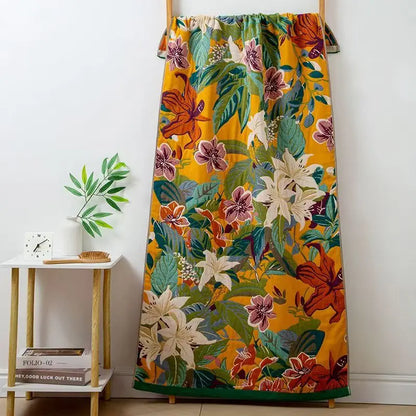 Colorful floral skirt hanging on a rack against a white wall.