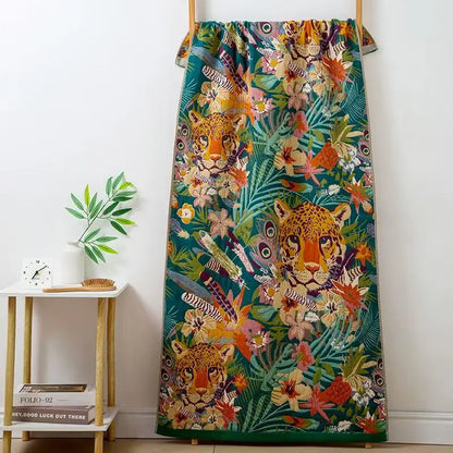 Colorful curtain with tiger and floral pattern hanging on a wooden rod against a white wall.