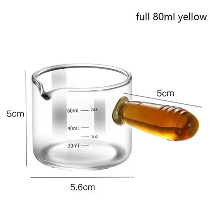 Glass measuring cup with honey and measurements on a white background