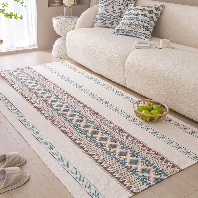 Patterned rug on a wooden floor in a living room with a sofa and decorative items.