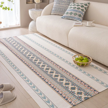 Patterned rug on a wooden floor in a living room with a sofa and decorative items.