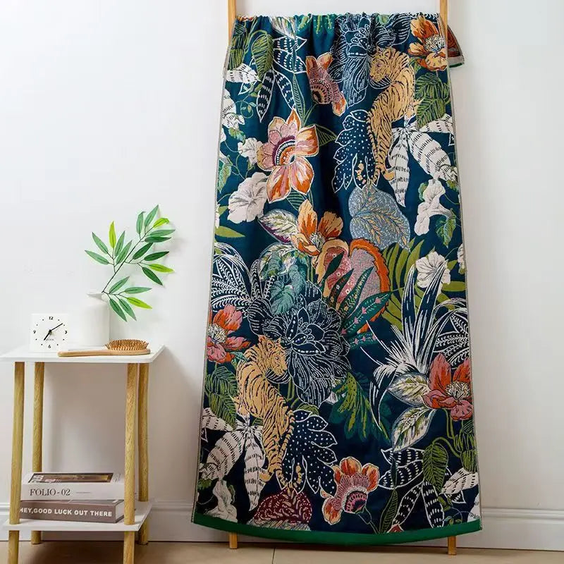 Floral and animal patterned curtain on a wooden rod against a white wall.