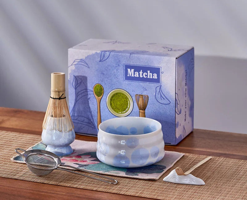 Matcha tea set with bowl, whisk, and box on a wooden surface