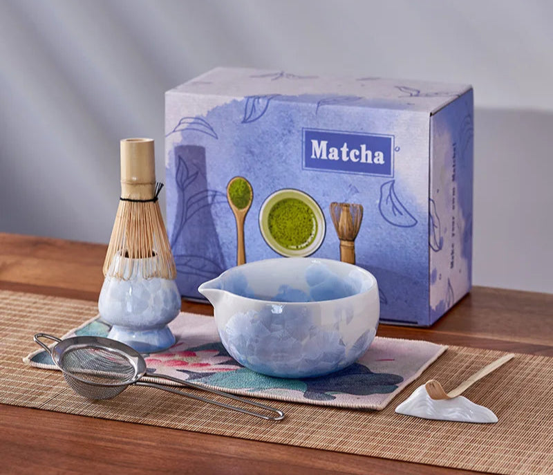 Matcha tea set with bowl, whisk, and box on a wooden table