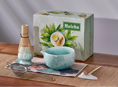 Matcha tea set with a box labeled 'Matcha' on a wooden table.