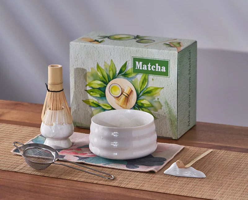 Matcha tea set with a box labeled 'Matcha' on a wooden surface.