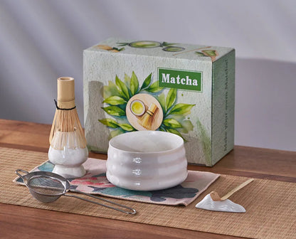 Matcha tea set with a box labeled 'Matcha' on a wooden surface.
