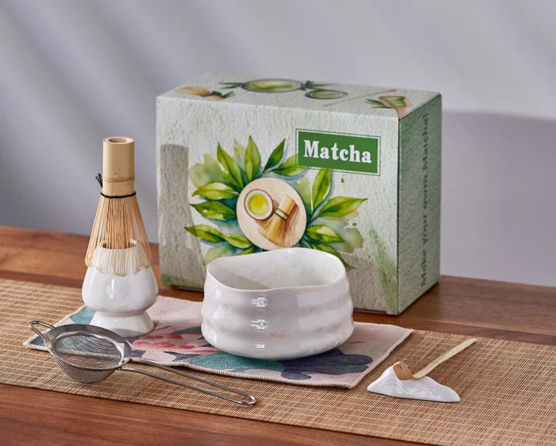 Matcha tea set with a box labeled 'Matcha' on a wooden surface.