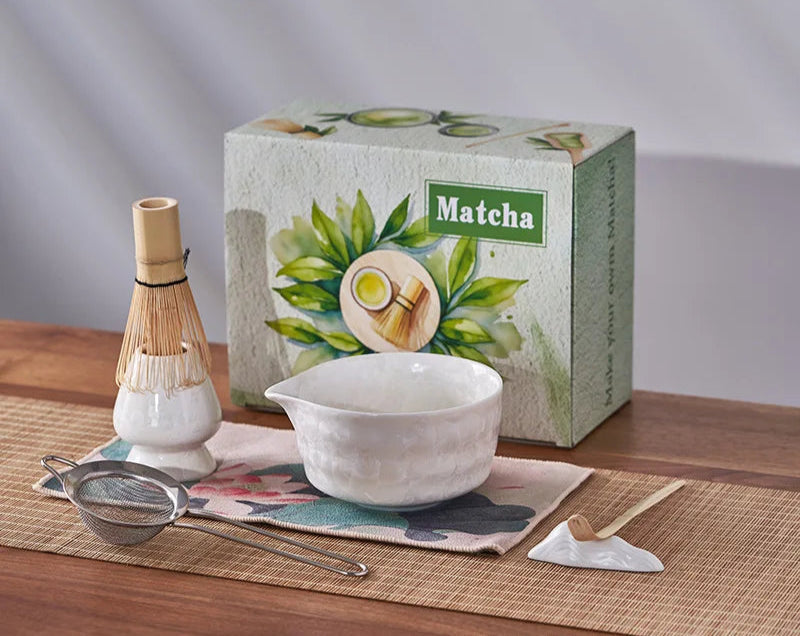 Matcha tea set with a box labeled 'Matcha' on a wooden surface.