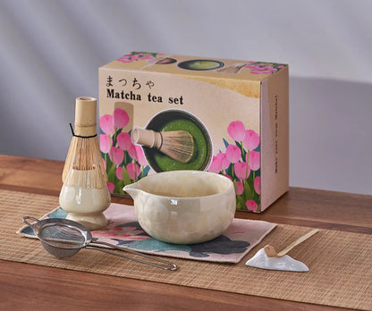 Matcha tea set with packaging on a wooden surface