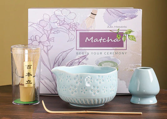 Matcha tea set with a box labeled 'Matcha' on a wooden surface.