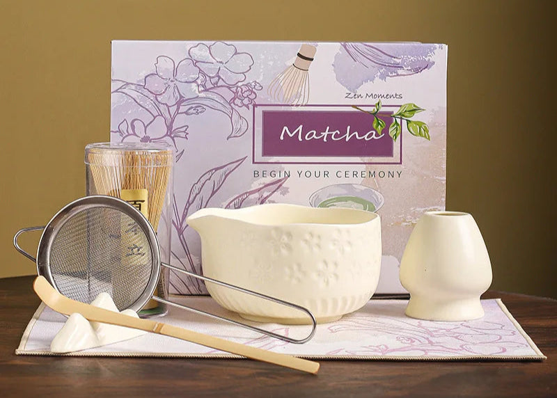 Matcha tea preparation set with a box labeled 'Matcha' on a wooden surface.