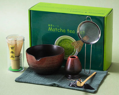 Matcha tea set with bowl, whisk, and other tools in front of a green box labeled 'Matcha tea set'.