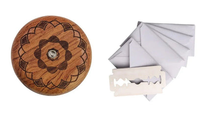 Wooden button with floral design and a white razor on a white background