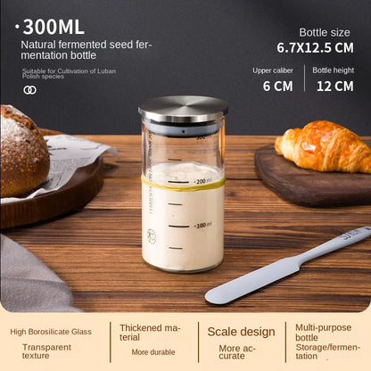 300ml natural fermented seed fermentation bottle on a wooden surface with bread and a croissant.